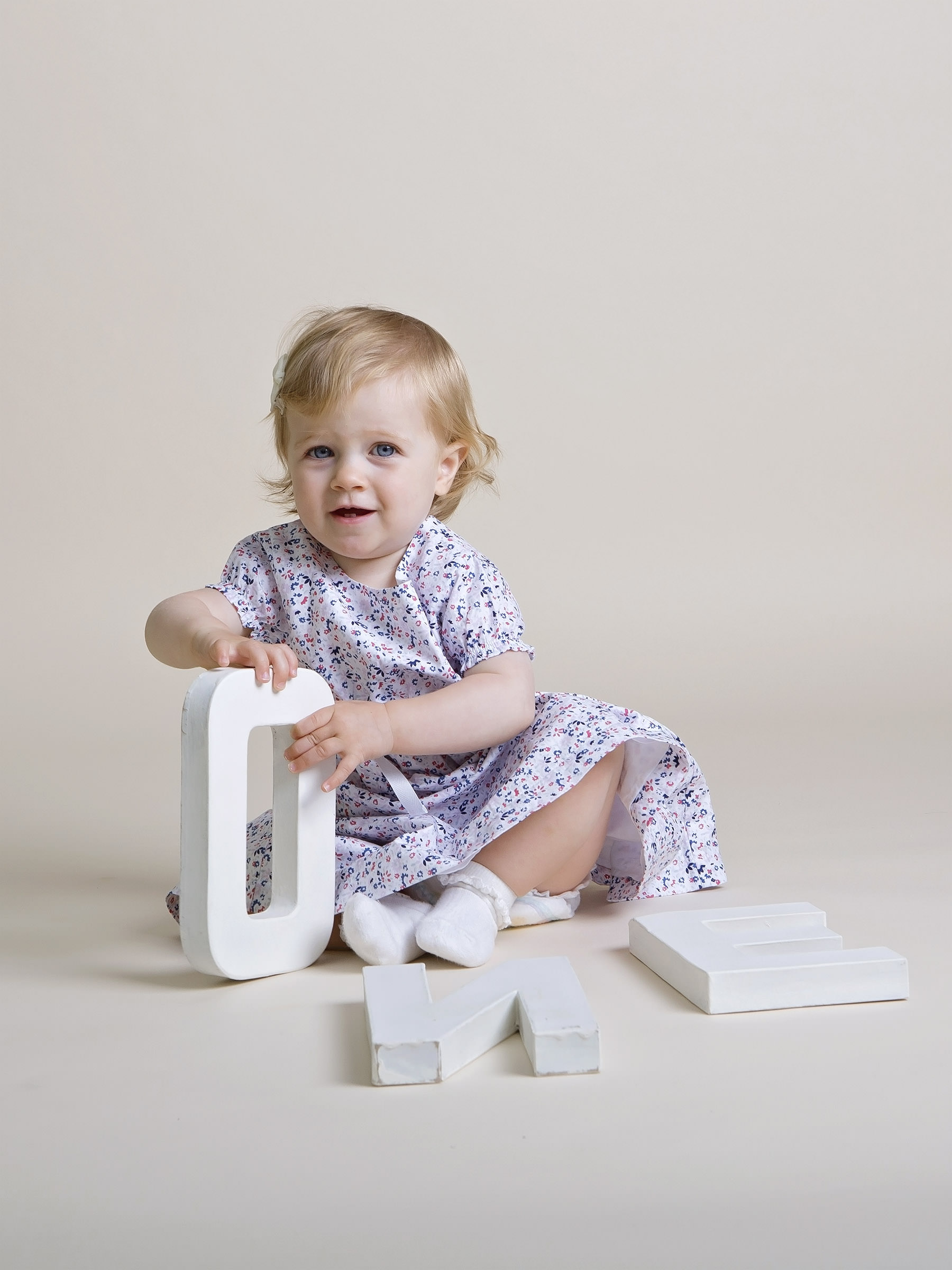 baby playing with wooden letters by family photographer Winchester