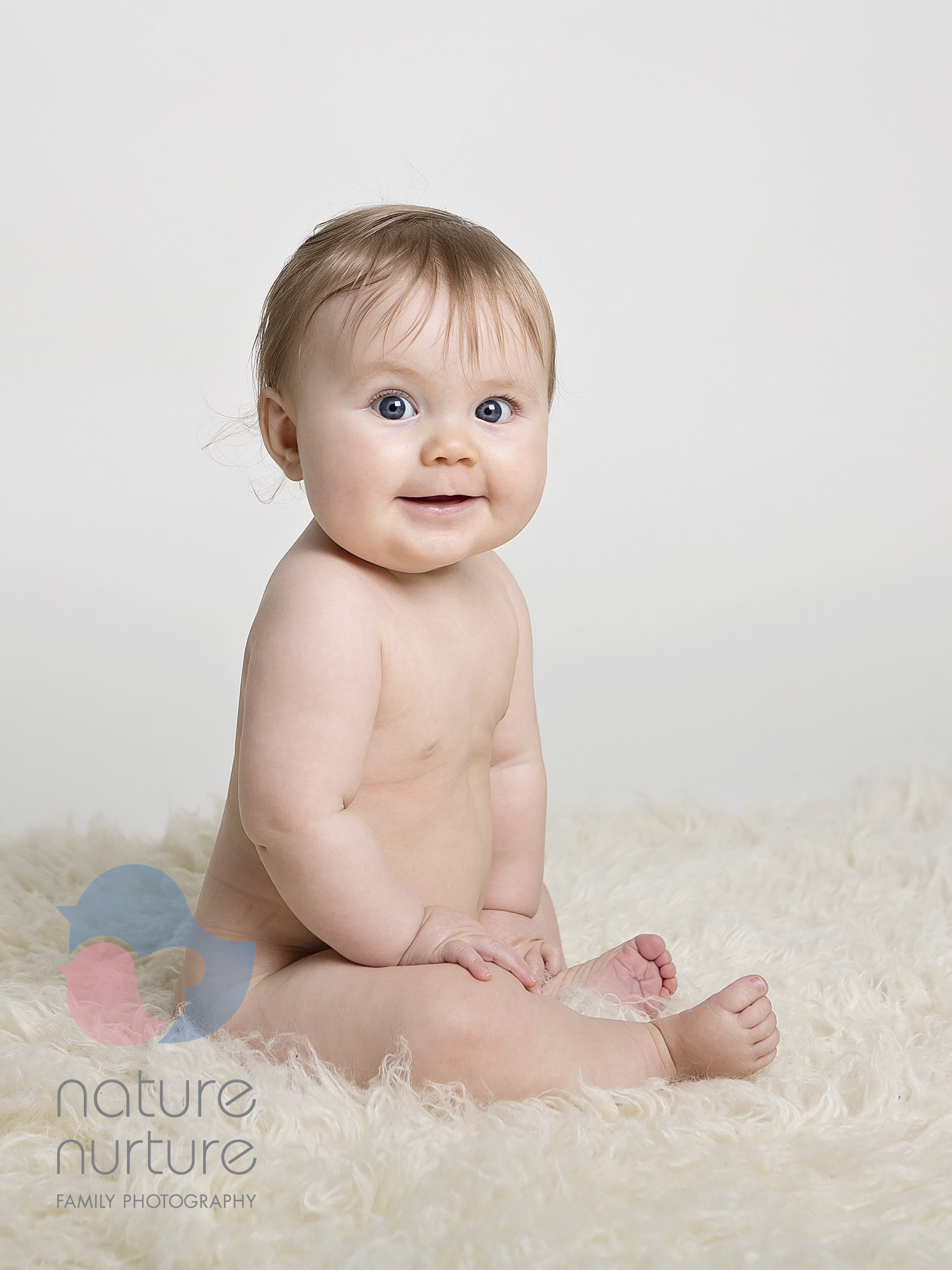 baby sitting on cream fluffy rug by Winchester family photographer