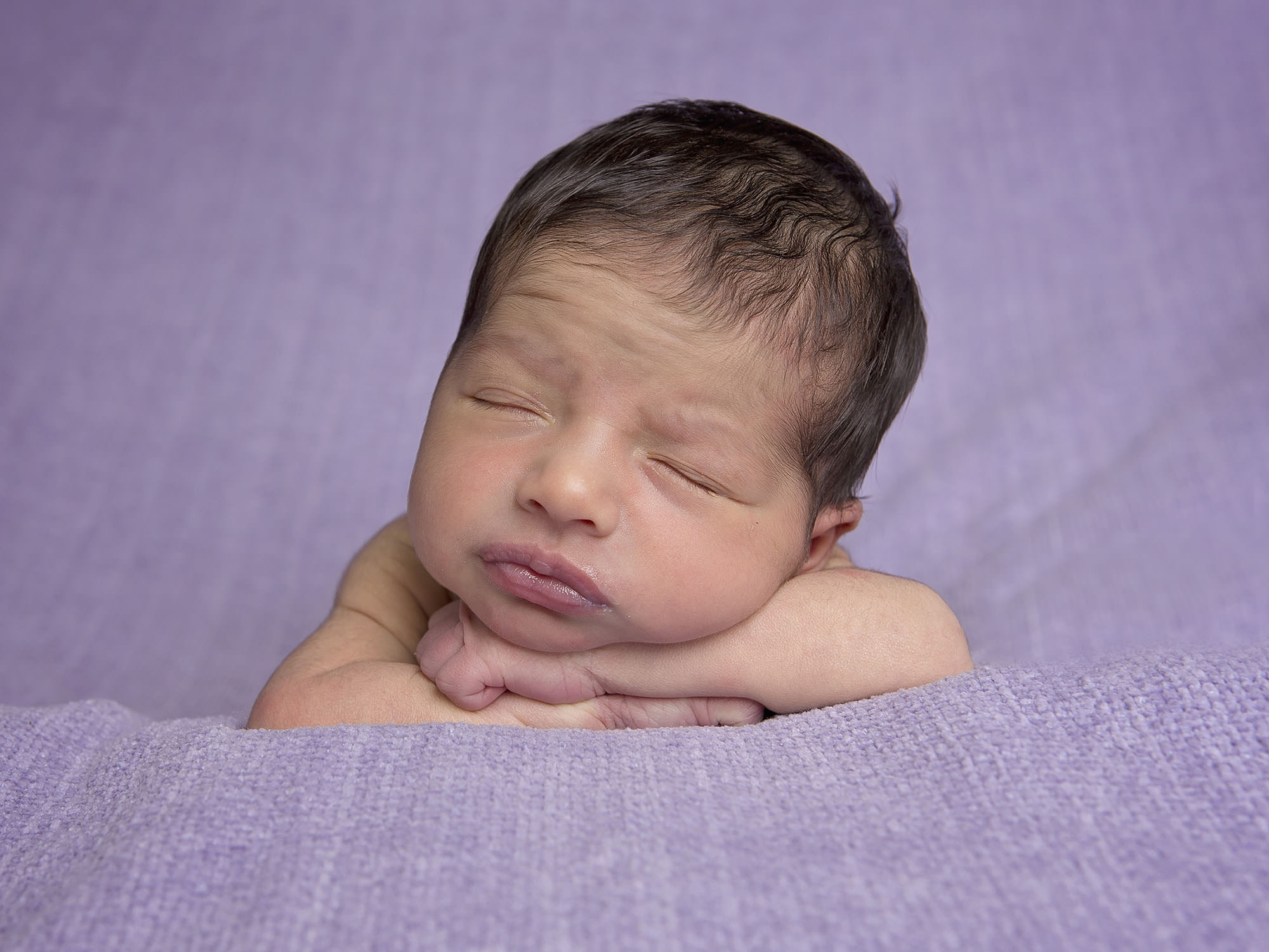 newborn on purple blanket by newborn photographer Winchester