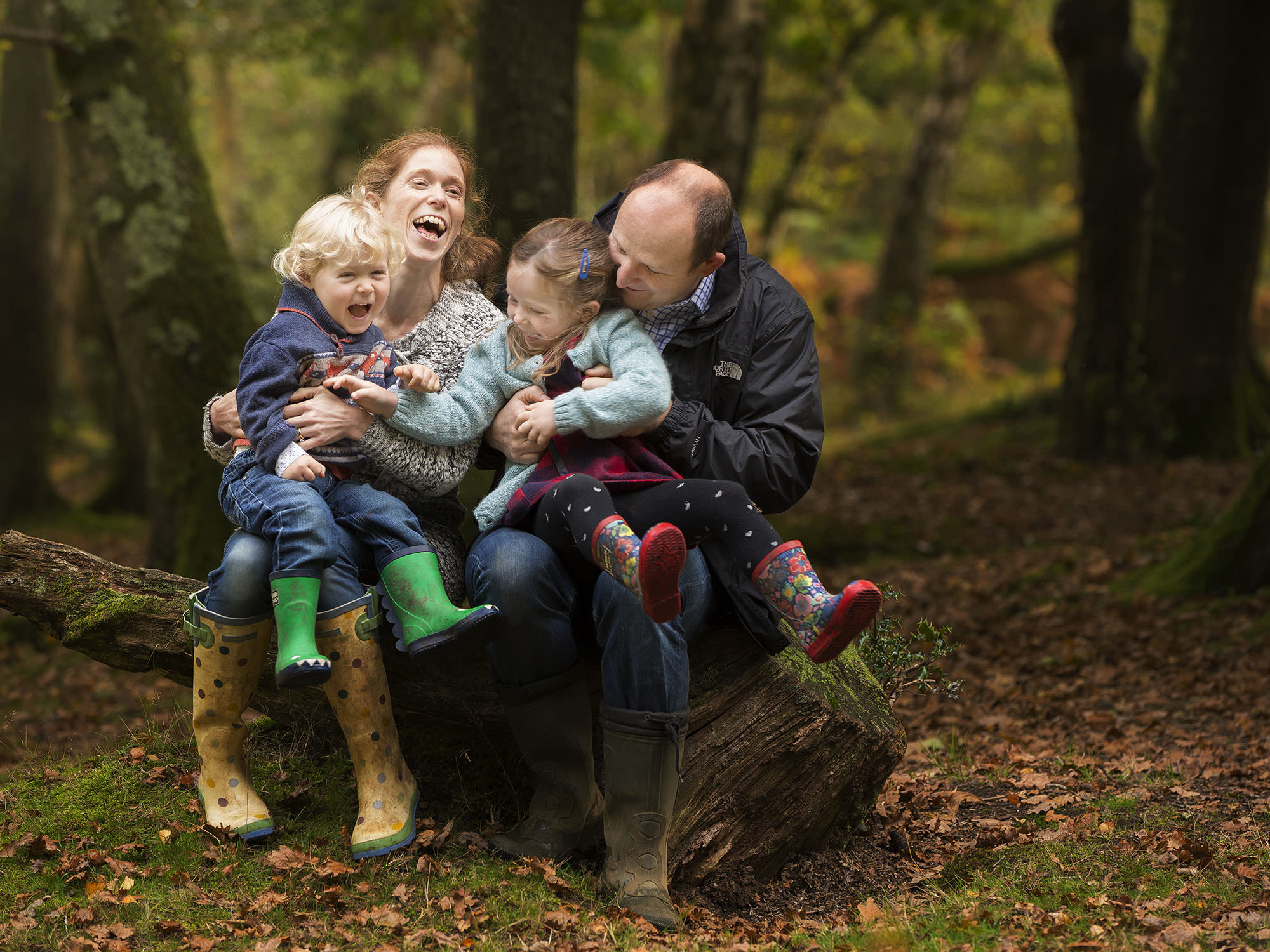 Mum and dad with two toddlers by family photographer Winchester