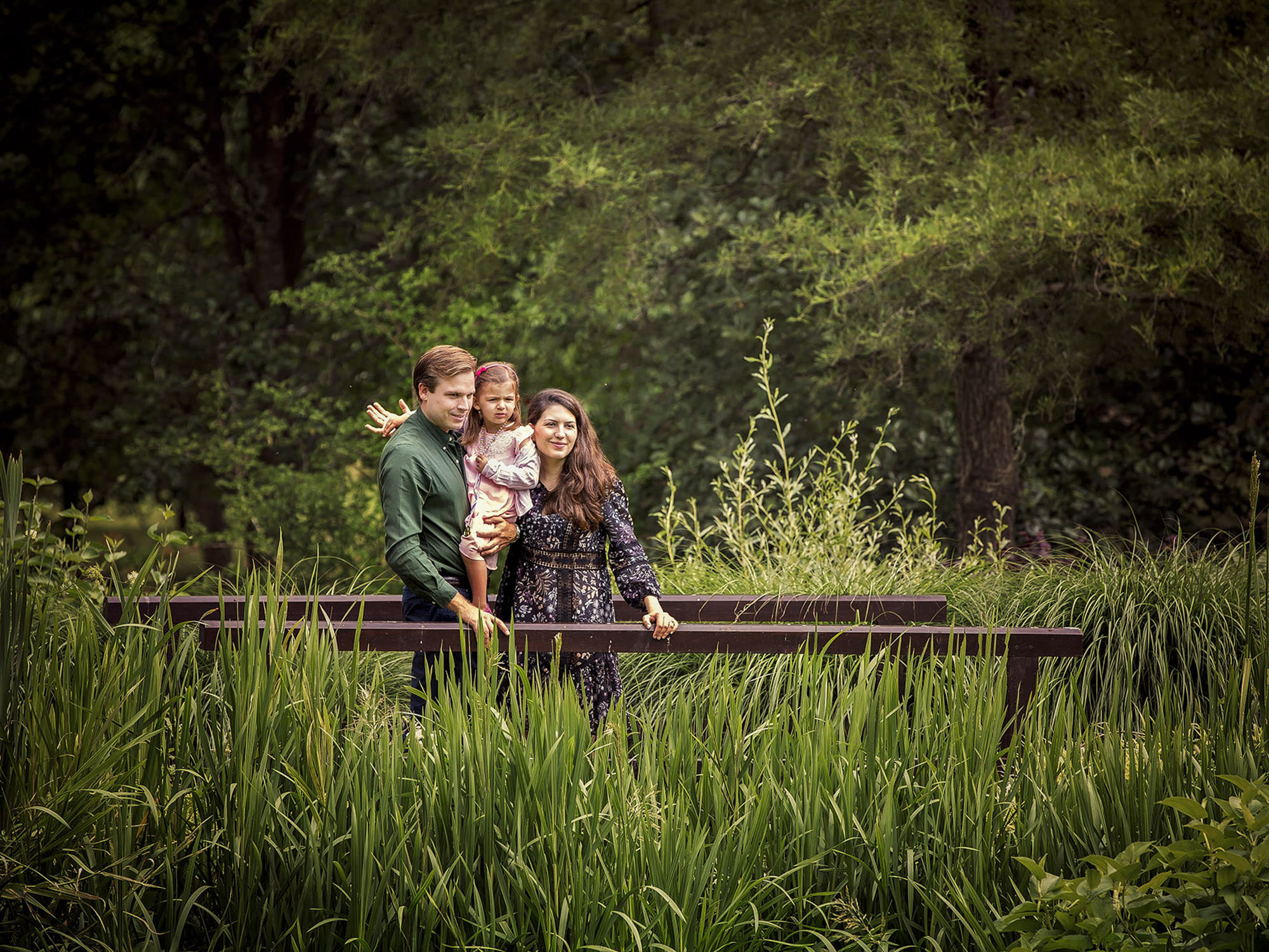 Parents and child outdoors by family photographer Winchester