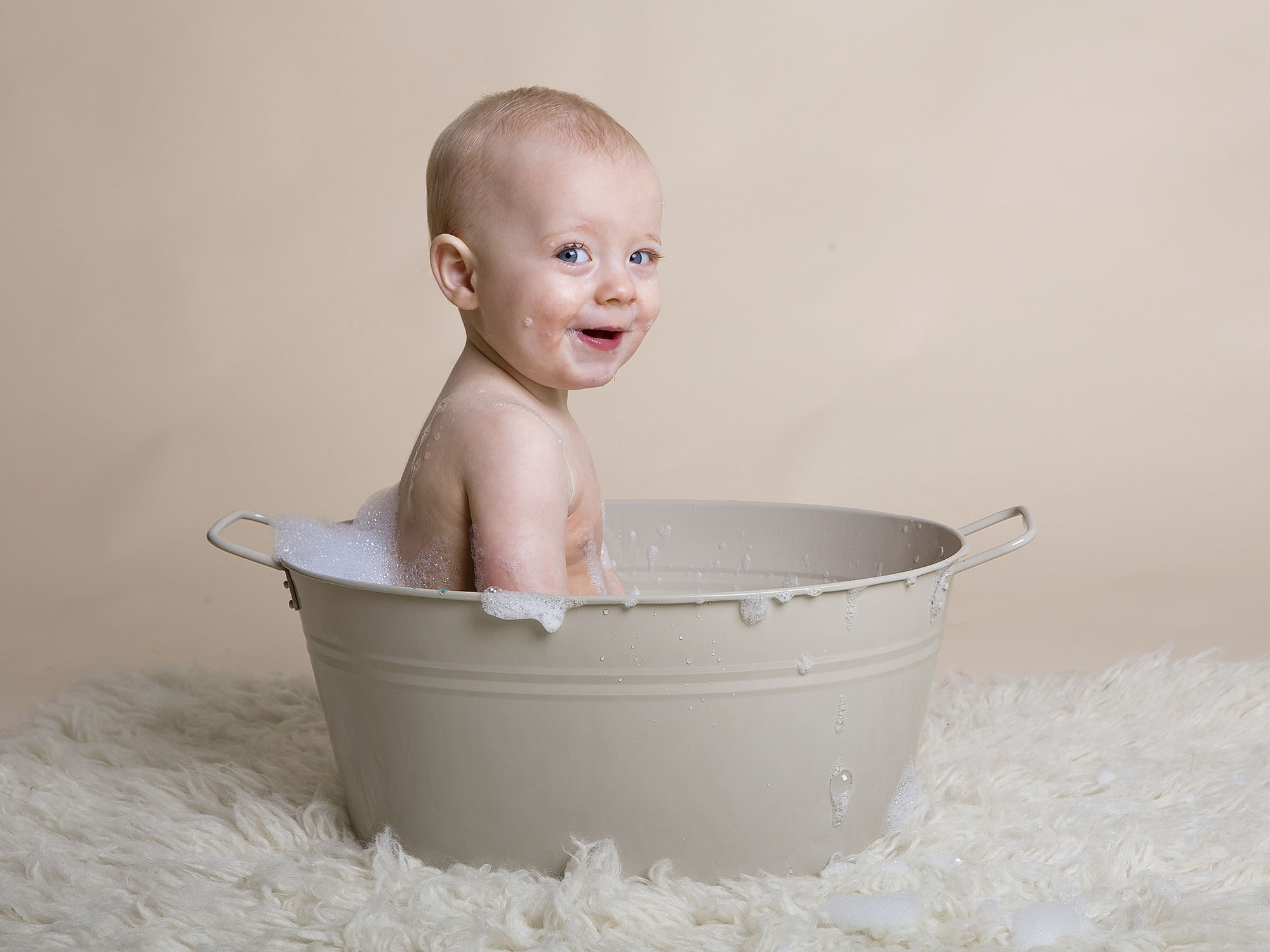 baby laughing in bubble bath cake smash photographer Hampshire