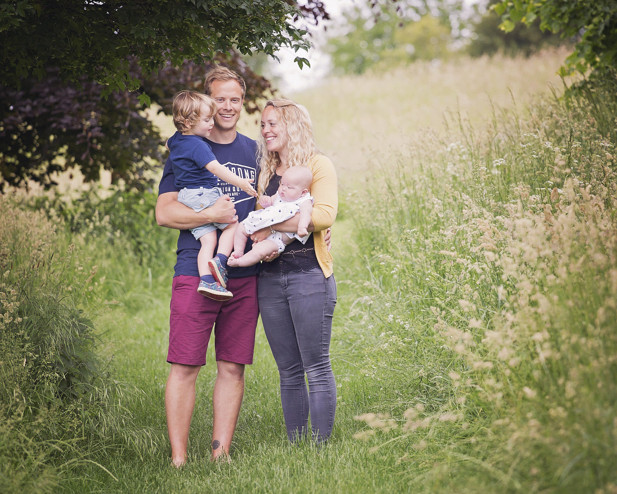 Family together outdoors by family photographer Winchester