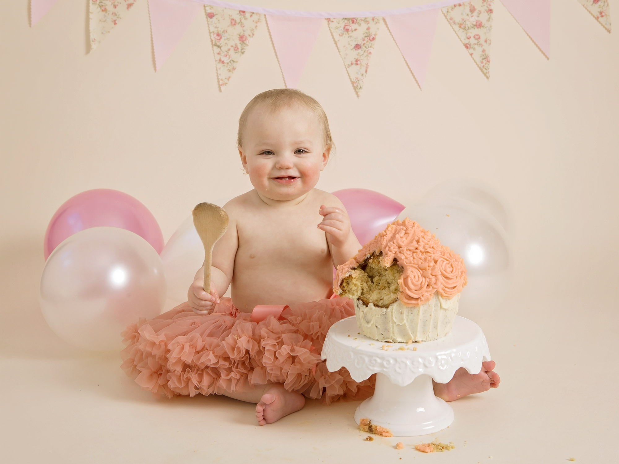 baby girl in tutu eating cake by cake smash photographer Winchester