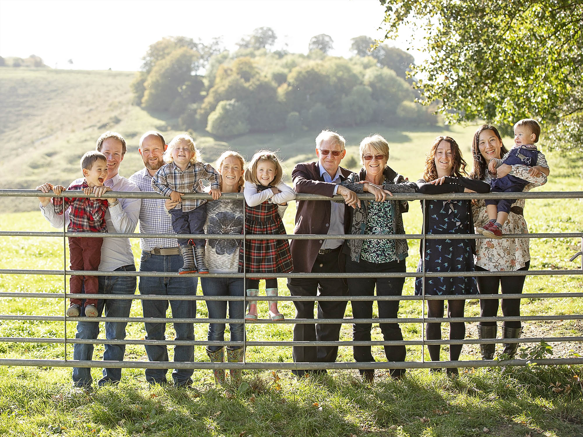 large family on a gate by family photographer Winchester