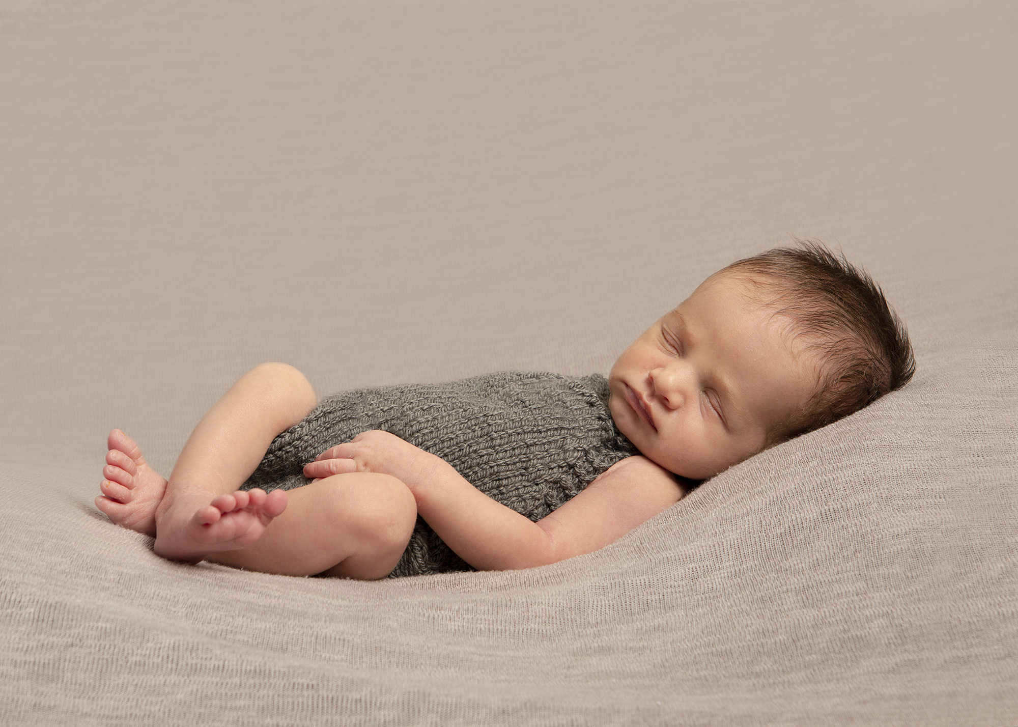 baby asleep on brown blanket by newborn photographer Hampshire