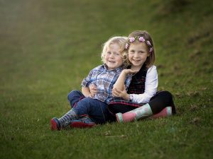 siblings cuddling by family photographer Hampshire
