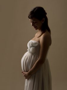 maternity silhouette in white flowing dress
