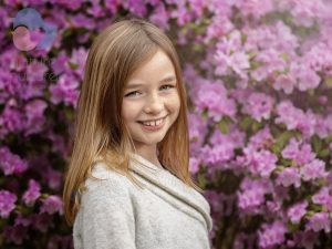 girl smiling with pink flowers