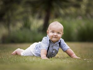 baby crawling on grass