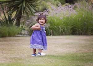 little girl in purple dress at Hilliers Arboretum