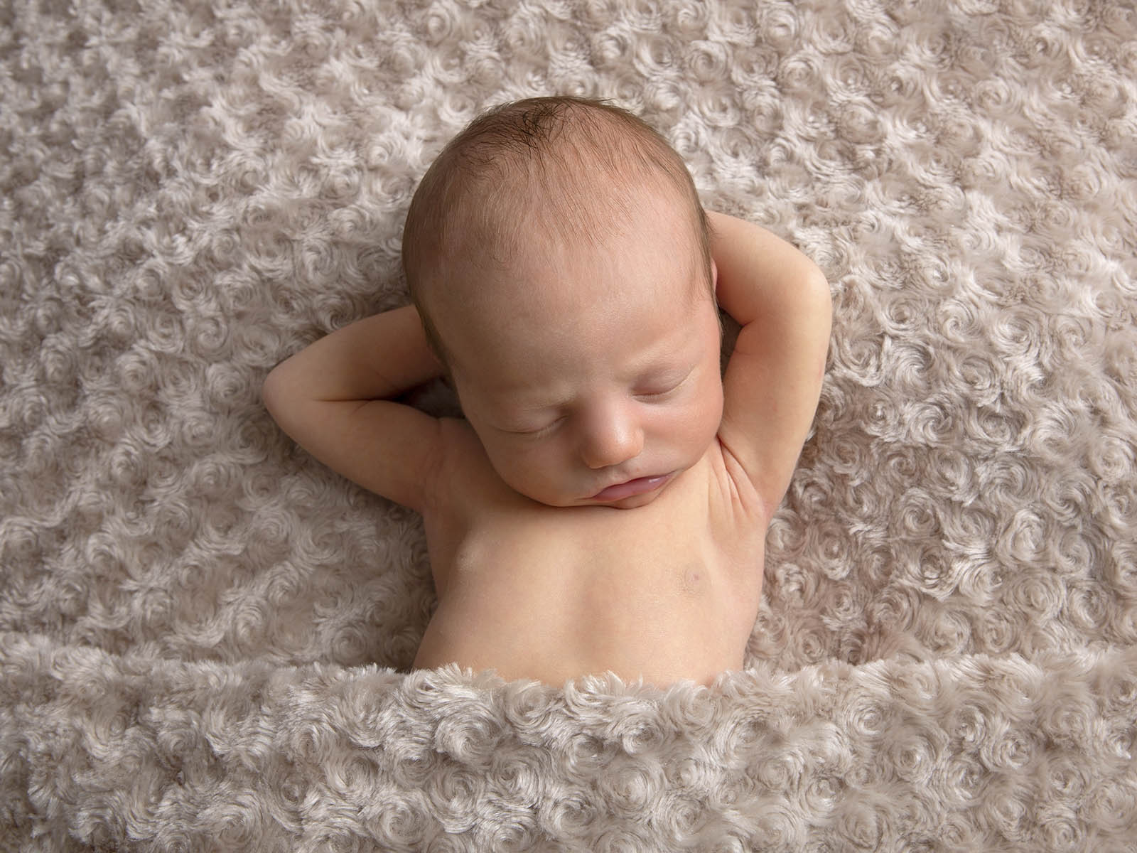 relaxed newborn baby in Hampshire studio