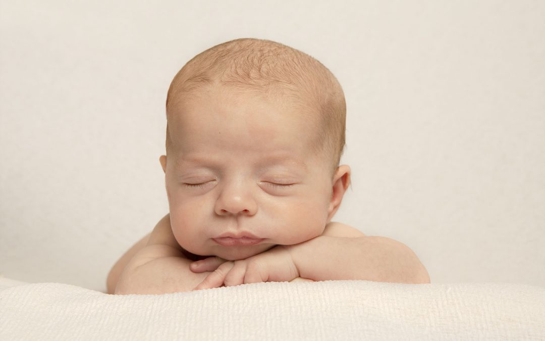 sleeping newborn on white background