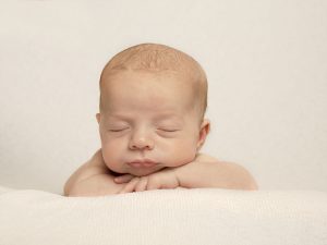 sleeping newborn on white background