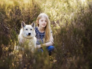 girl and dog in the woods