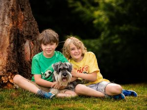 Boys and their dog under tree