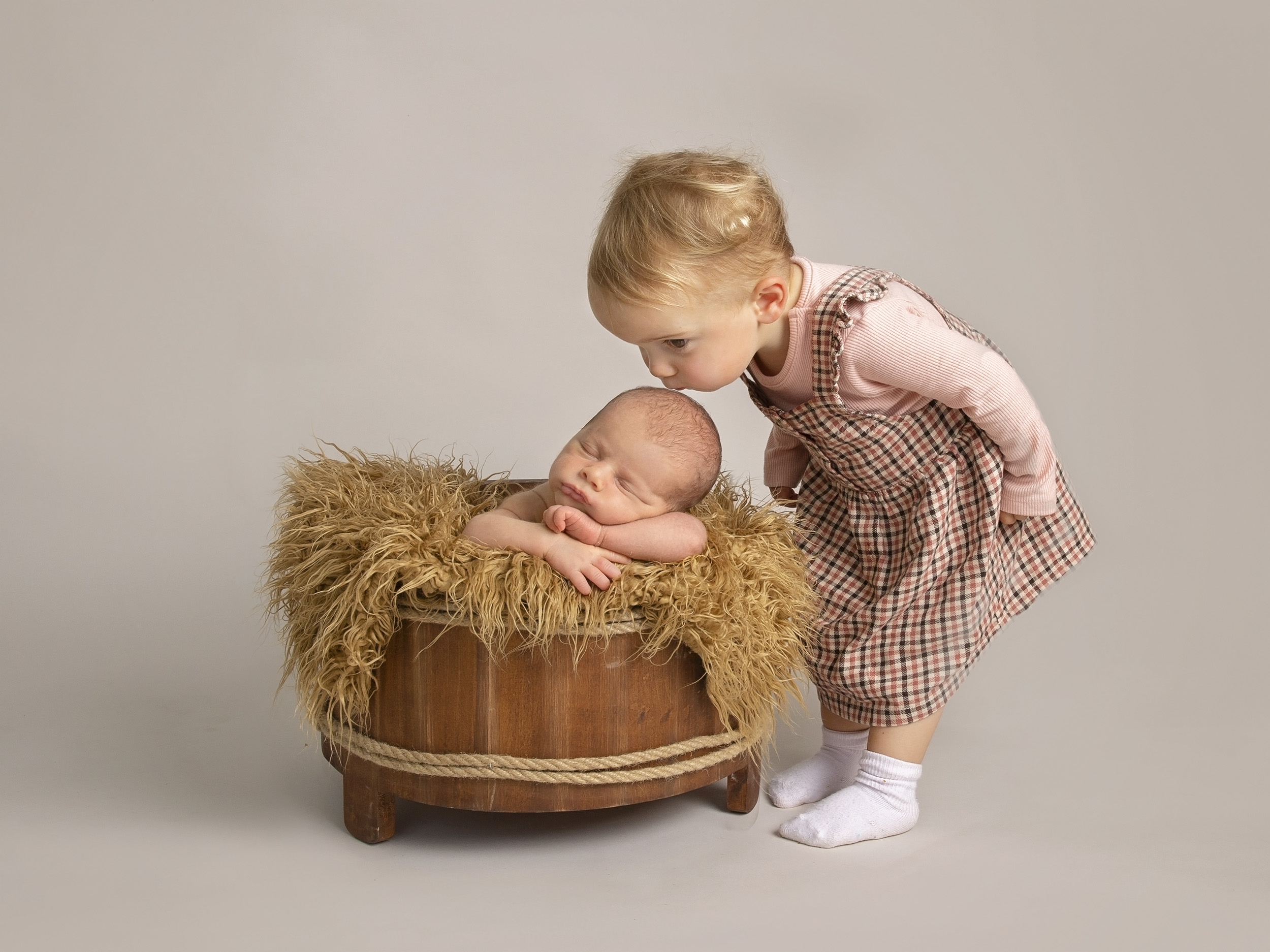 little girl kissing new baby by Winchester newborn photographer