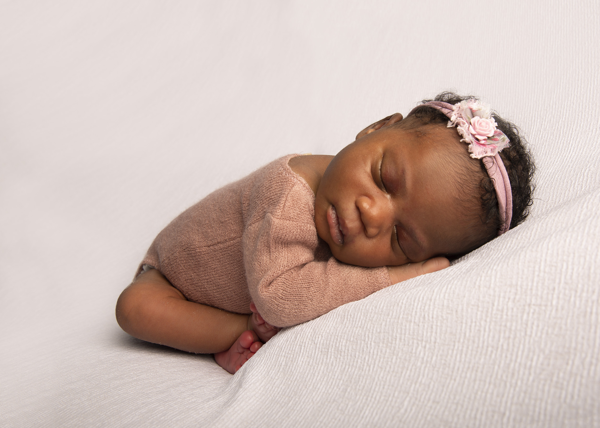 Curled up new baby by Winchester newborn photographer