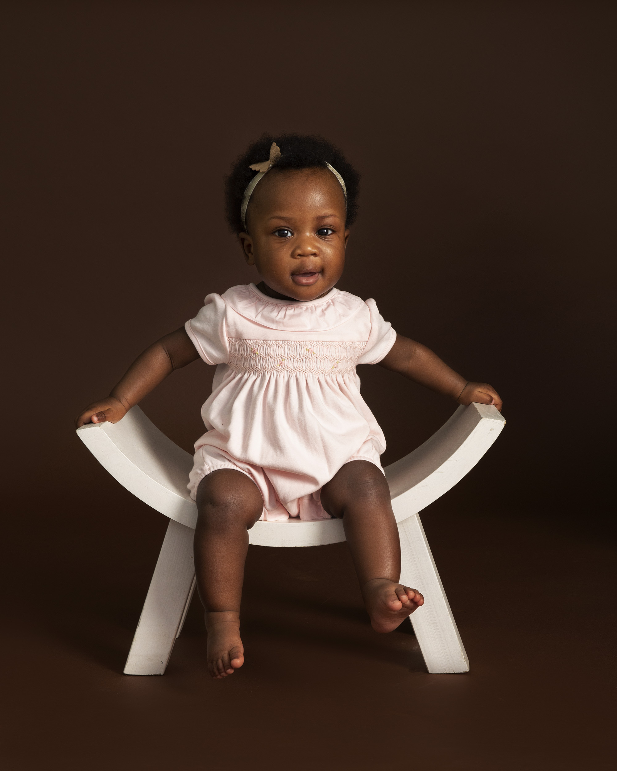 Baby sitting on stool by Hampshire family photographer